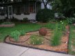 Newly planted bed in a front corner of a yard